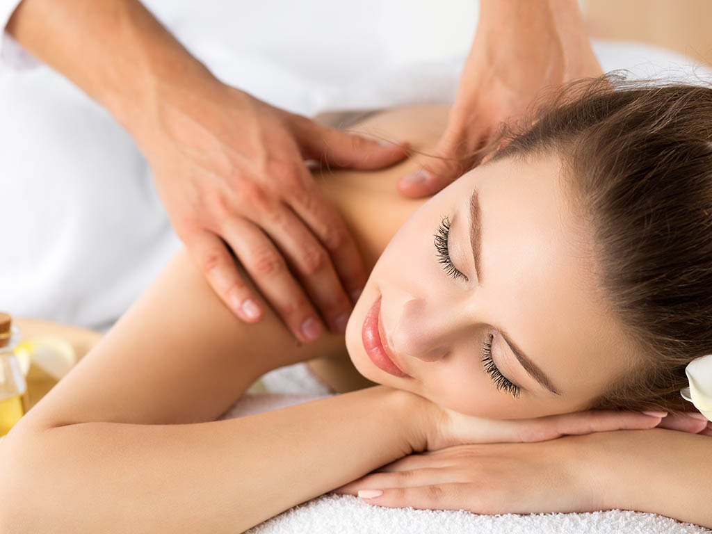 Beautiful young woman laying at spa salon